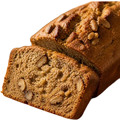 A thick slab of banana bread on parchment, the top split and dark gold.