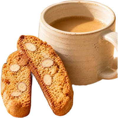 Almond biscotti stood on end in a shallow dish beside a cup of black coffee.